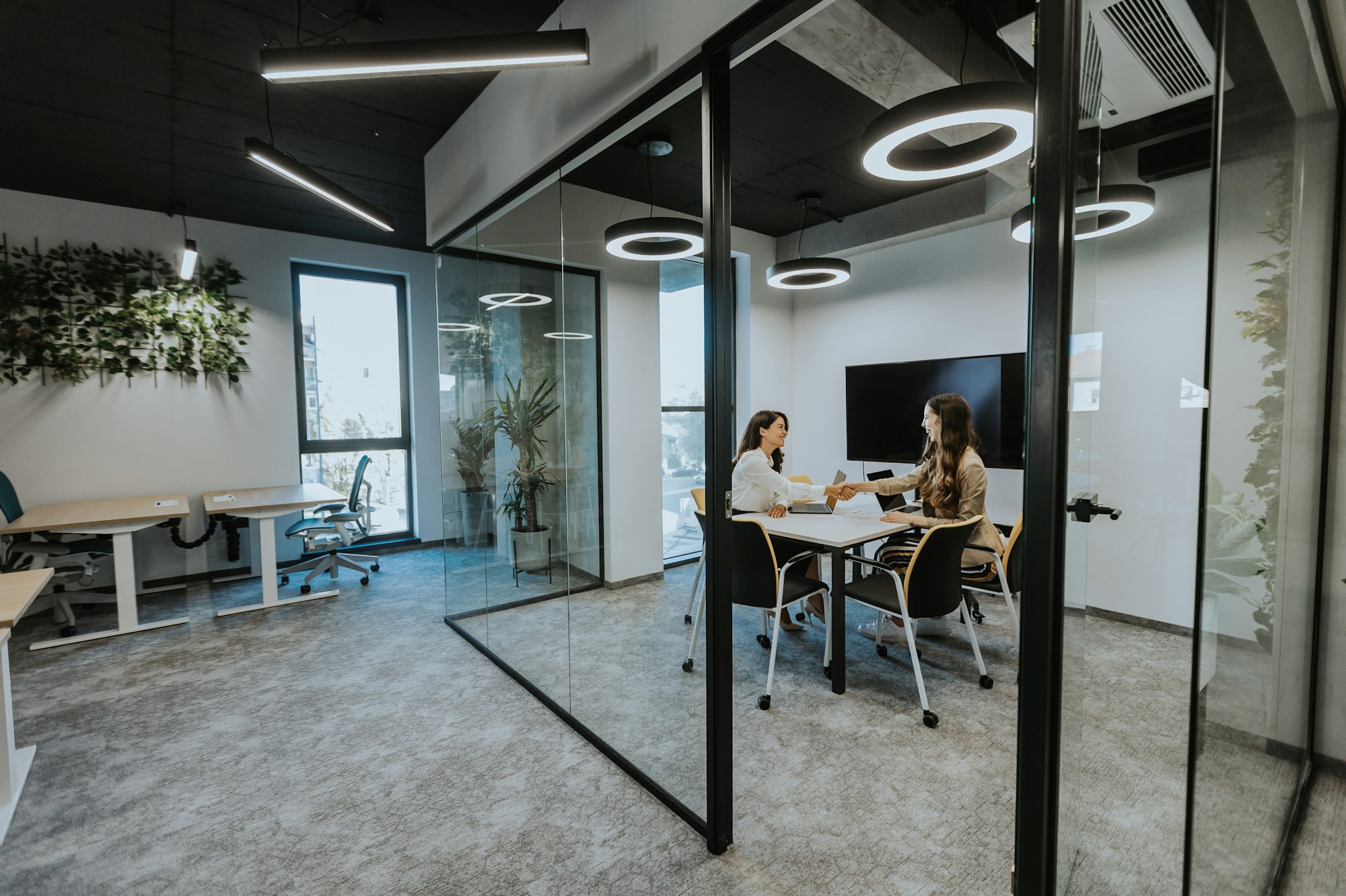 Young business women discussing in cubicle at the office